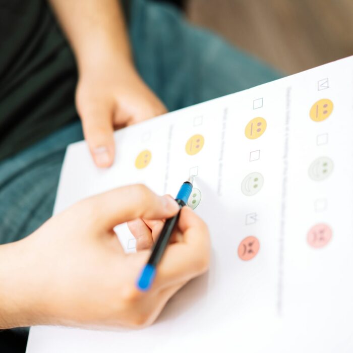 Man taking a psychological test with emoticons